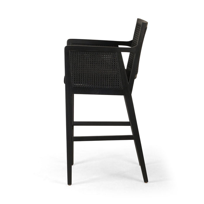 Ebony finished nettlewood frames a textural inlay of dark cane arms and back with top grain dark leather seat with brass kickplate counter stool shopkoehndesign calgary furniture shop amy koehn calgary designer
