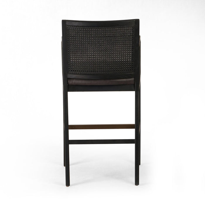 Ebony finished nettlewood frames a textural inlay of dark cane arms and back with top grain dark leather seat with brass kickplate counter stool shopkoehndesign calgary furniture shop amy koehn calgary designer