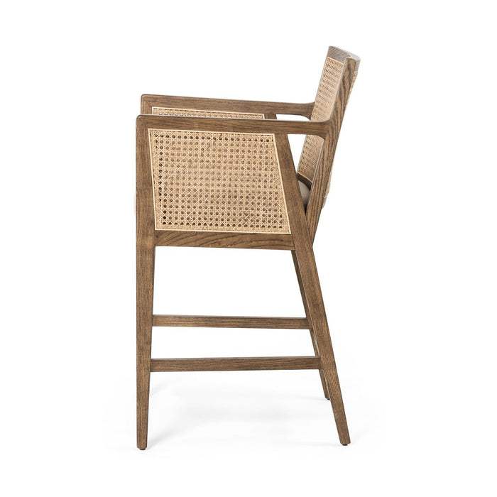 Light-toasted nettlewood frames a textural inlay of natural cane arms and back with a light, linen-blend seat of high-performance fabric counter stool shopkoehndesign calgary furniture shop amy koehn calgary designer