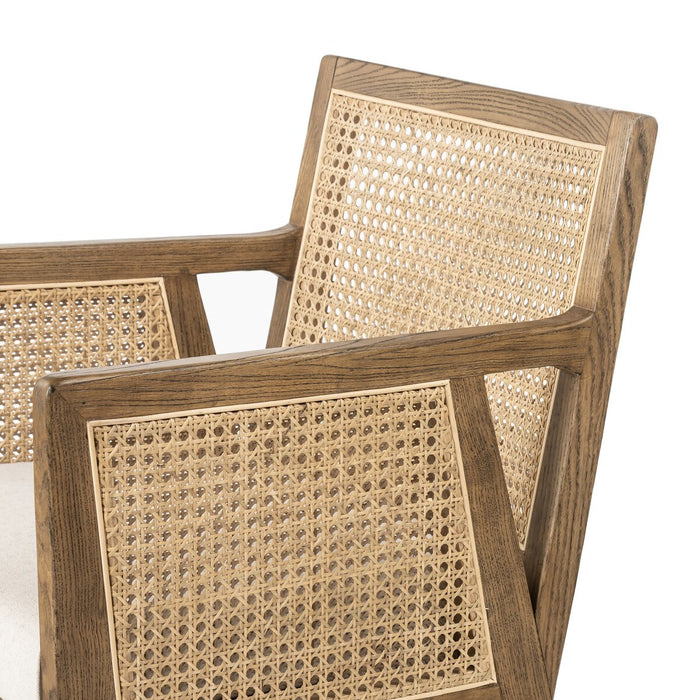 Light-toasted nettlewood frames a textural inlay of natural cane arms and back with a light, linen-blend seat of high-performance fabric counter stool shopkoehndesign calgary furniture shop amy koehn calgary designer