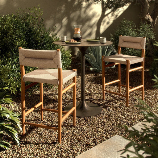 slim, tapered teak frames this woven all-weather wicker counter stool shopkoehndesign interior design calgary furniture shop amy koehn calgary designer