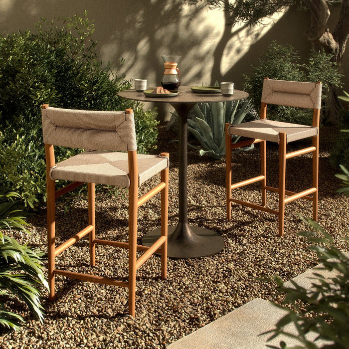 slim, tapered teak frames this woven all-weather wicker counter stool shopkoehndesign interior design calgary furniture shop amy koehn calgary designer  