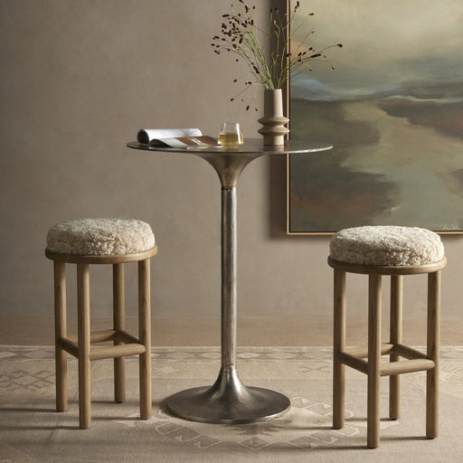 solid parawood round stool with soft beige shearling cushion armless and backless counter stool shopkoehndesign calgary furniture shop amy koehn calgary designer