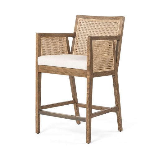 Light-toasted nettlewood frames a textural inlay of natural cane arms and back with a light, linen-blend seat of high-performance fabric counter stool shopkoehndesign calgary furniture shop amy koehn calgary designer
