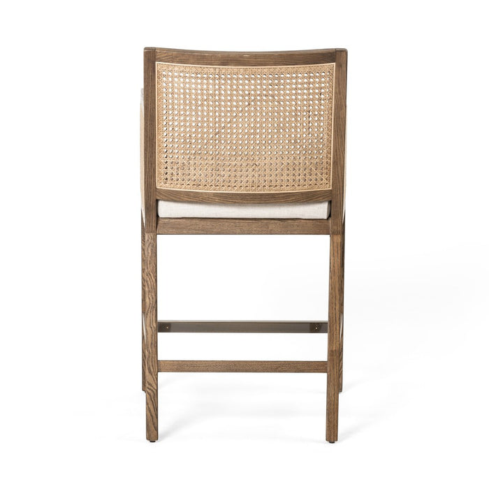 Light-toasted nettlewood frames a textural inlay of natural cane arms and back with a light, linen-blend seat of high-performance fabric counter stool shopkoehndesign calgary furniture shop amy koehn calgary designer 