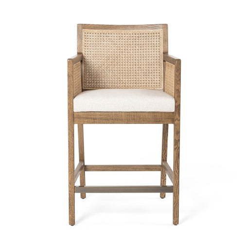 Light-toasted nettlewood frames a textural inlay of natural cane arms and back with a light, linen-blend seat of high-performance fabric counter stool shopkoehndesign calgary furniture shop amy koehn calgary designer
